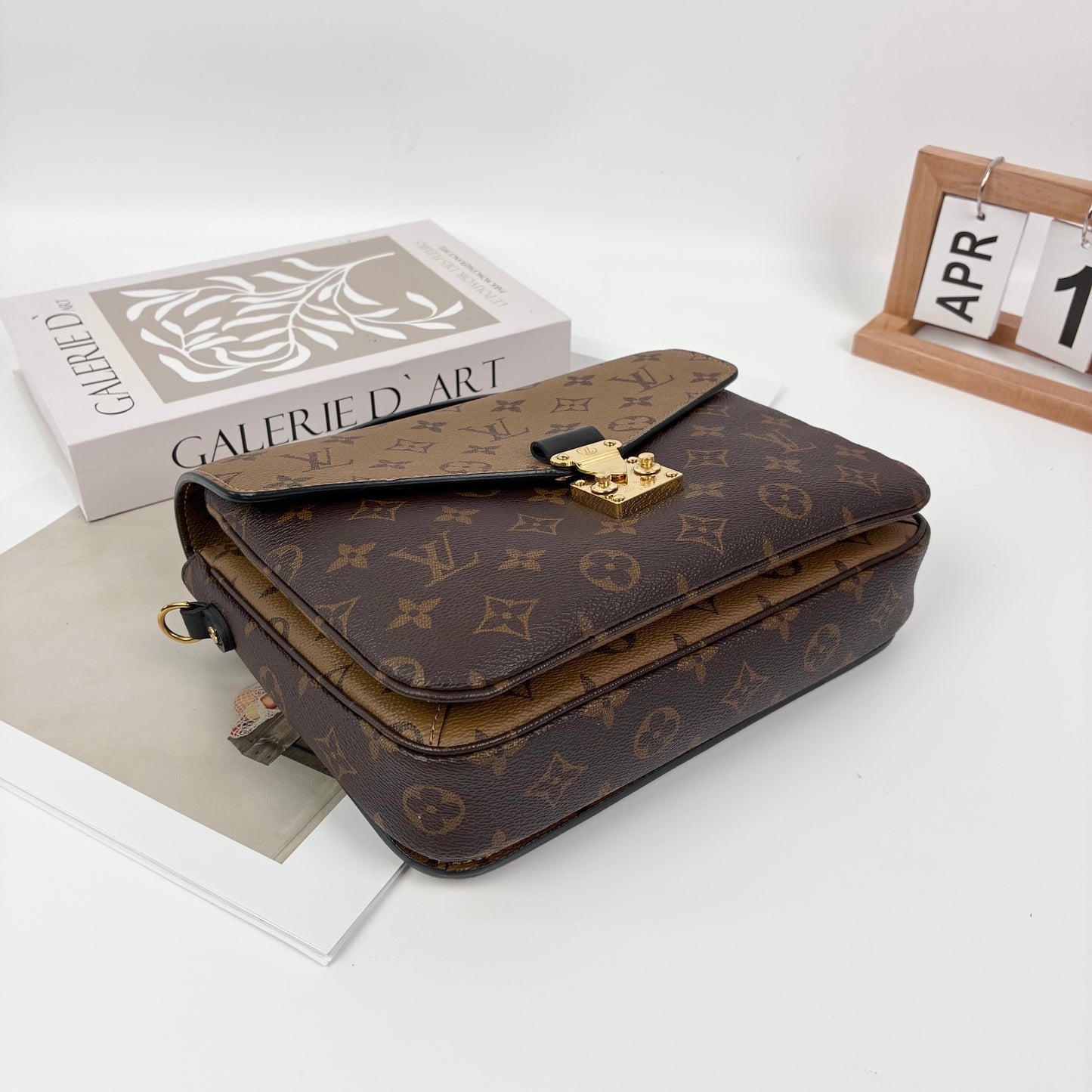Louis Vuitton Pochette Métis, Reverse Monogram Canvas, Gold-tone S-Lock Hardware